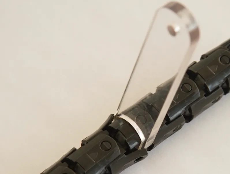 Single Rolliner roller element with welding wire threaded through the conical guide and crossing the roller pair, showing the core rolling contact mechanism